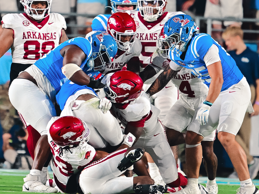 Arkansas defenders tackle an Ole Miss player.