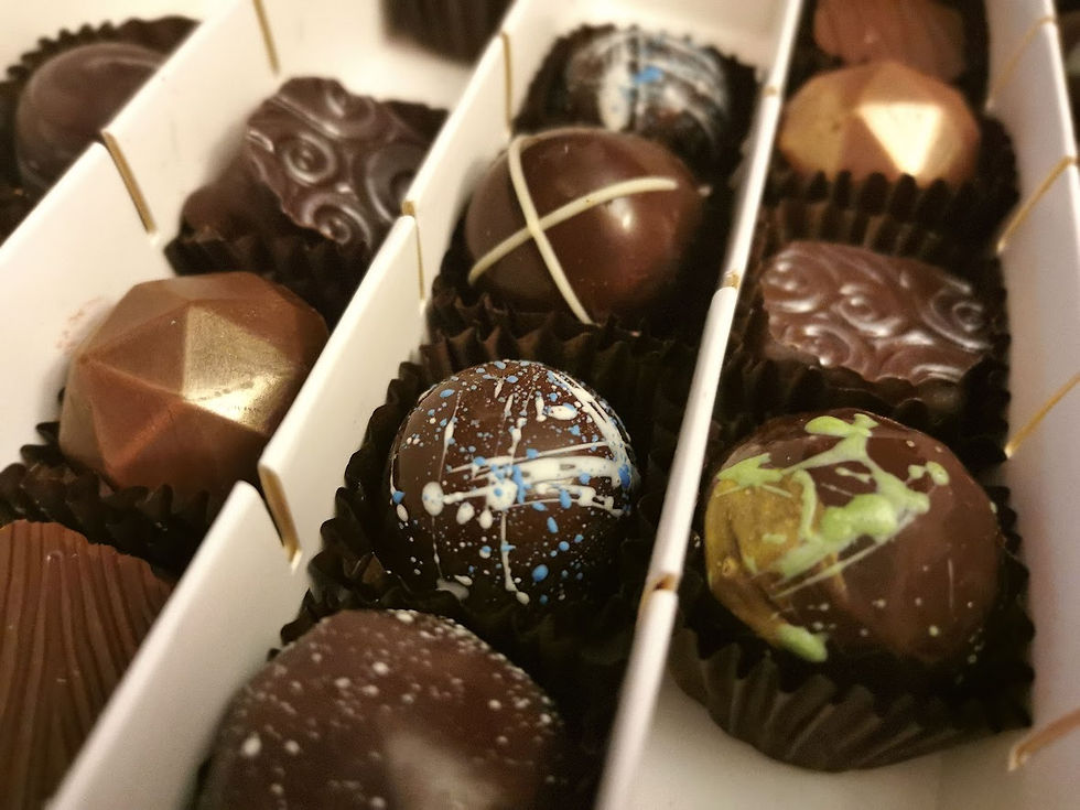 A box with various shaped and decorated chocolates.