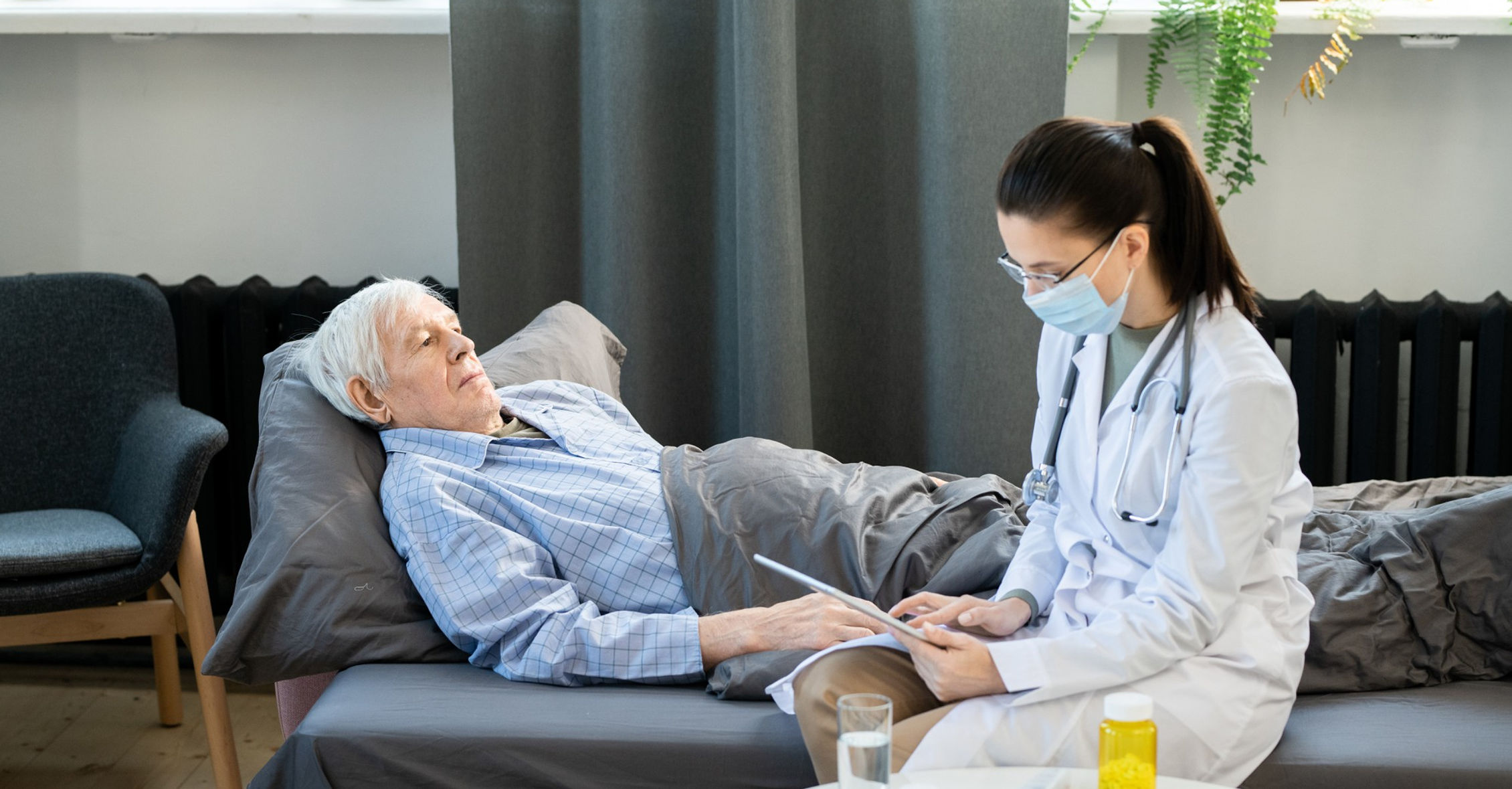 Caregiver and elderly patient in a warm home setting