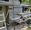 Rebuilt brick chimney with restored masonry and repaired crown