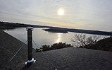 Professional chimney inspection on a lakefront home in Southwest Missouri during the winter heating season.