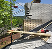Weathered brick chimney with deteriorated mortar joints requiring professional tuckpointing and masonry repair