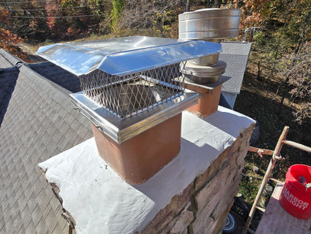 Custom stainless steel chimney cap installed on a masonry chimney with a freshly repaired chimney crown to protect against rain, animals, debris, and chimney water damage.