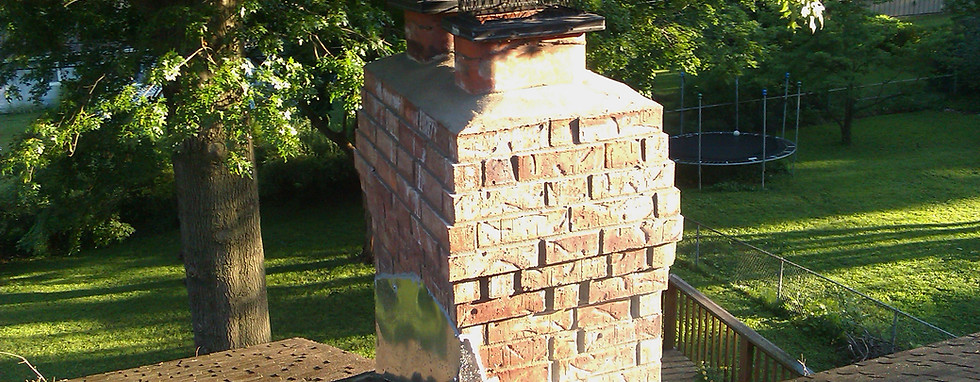 Deteriorated brick chimney with damaged mortar requiring masonry restoration