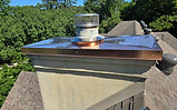 Professional chimney inspection of a masonry chimney cap and crown to identify damage and maintenance needs.