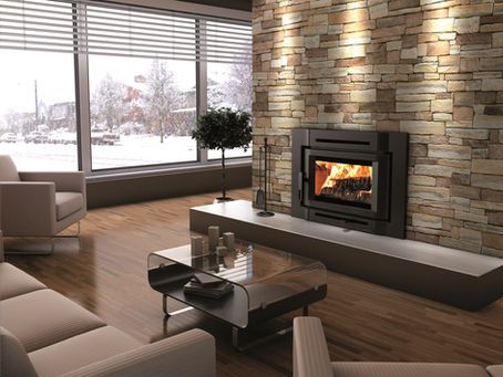 Modern wood-burning fireplace insert installed in a stone masonry fireplace to improve heating efficiency and home comfort.