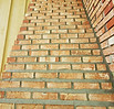Tuckpointing chimney shoulders to properly drain water