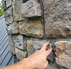 Close-up of deteriorated chimney mortar joints during masonry repair inspection