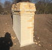 Cracked brick chimney crown and masonry damage before professional repair