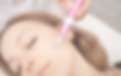 A woman's face with closed eyes during Microneedling or Microchanneling treatment