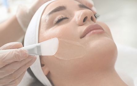 A woman's face with closed eyes during chemical peel treatment