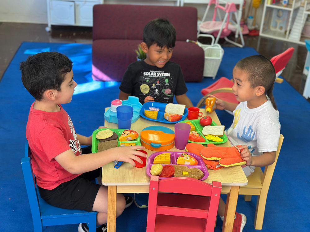 Young children playing pretend lunch