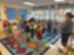 Children 2-5 participating in a preschool classroom activity