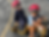 Two smiling boys in helmets on a tricycle