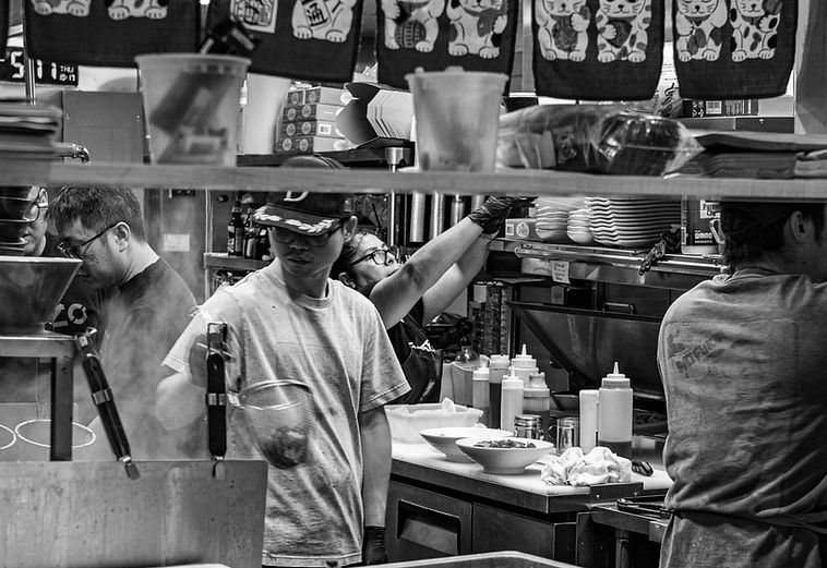 Chef preparing food in Yoshi Ramen restaurant kitchen