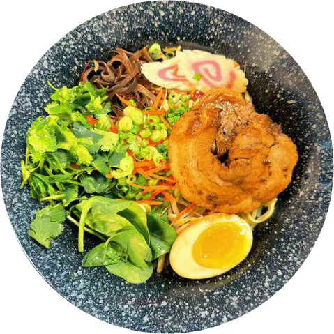 Delicious ramen bowl with pork, egg, and assorted vegetables