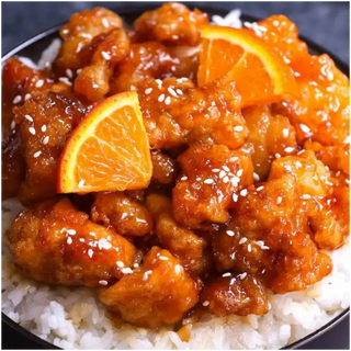 Delicious orange chicken with sesame seeds over rice