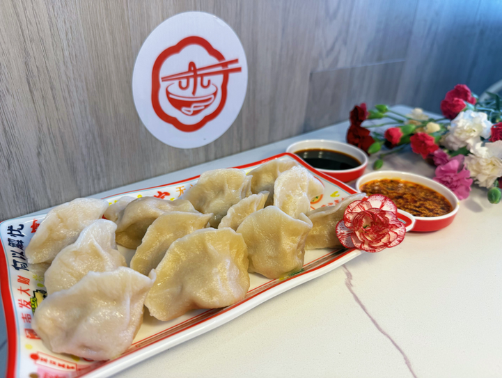 Plate of dumplings with soy sauce and chili oil, Li's KnifeCutNoodle restaurant.