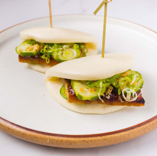 Two delicious unagi bao buns with cucumber and scallions