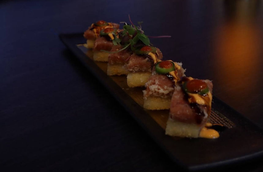 Delicious sushi appetizers on black plate