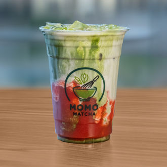 Iced matcha drink with layers and Momo Matcha logo on the cup.