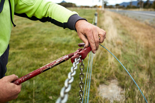 Fixing a wire fence on a farm