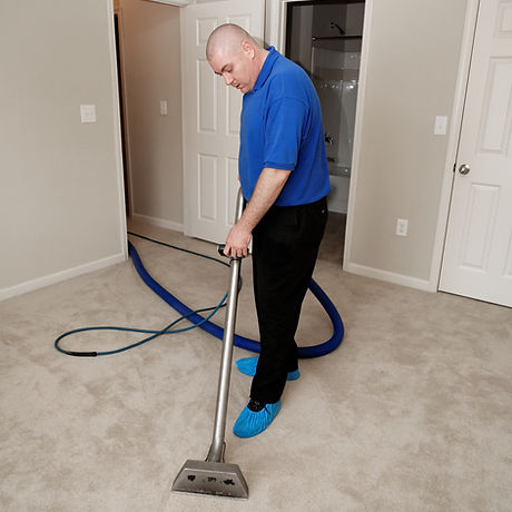 Man cleaning carpet with commercial cleaning equipment.jpg