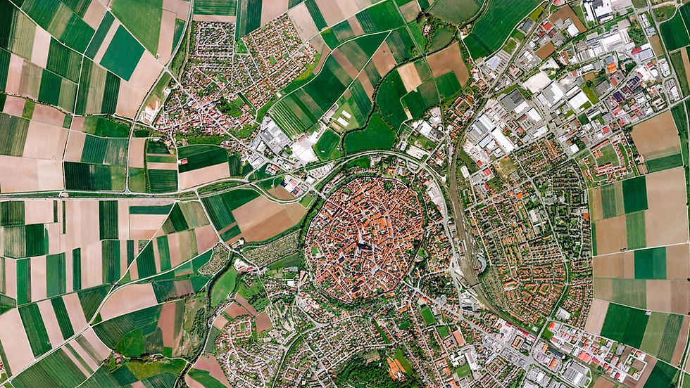 High-resolution satellite view of the circular, historic walled town of Nördlingen, Germany, surrounded by agricultural fields and modern developments, used to demonstrate geospatial AI.