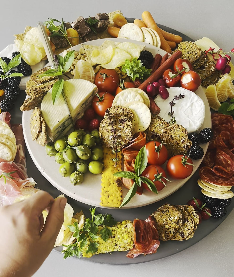 Thumbnail: Round handcrafted concrete Lazy Susan displaying cheese and charcuterie