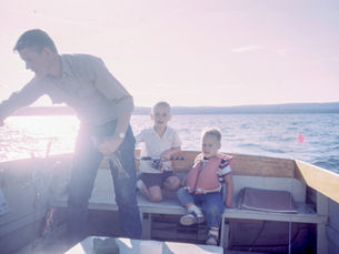 Father and children sharing a fishing trip on a lake, representing family memories, life lessons, and the lasting legacy often celebrated in a father's eulogy.