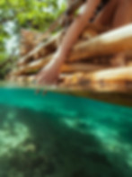 Website design for Jamaica, featuring girl riding a raft on river