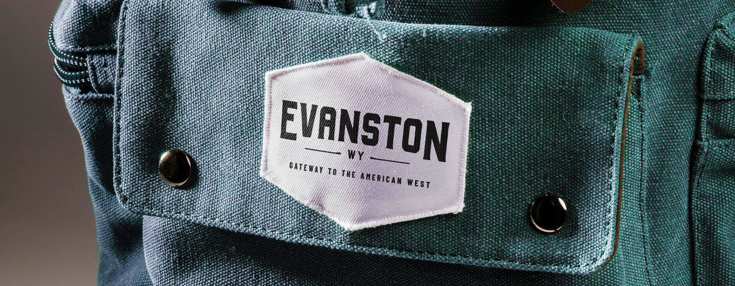 Mockup of Visit Evanston badge on a blue backpack