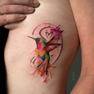 bird tattoo on ribs colourful