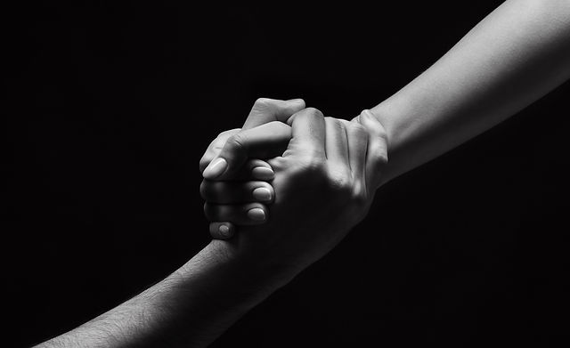 unrecognizable-woman-hand-helping-man-to