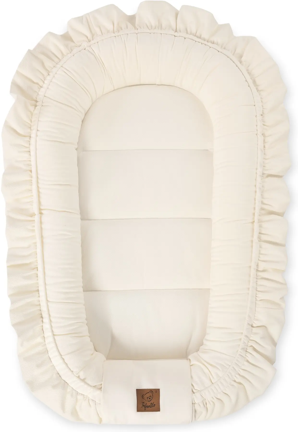 Off white velvet baby nest cocoon with decorative ruffle placed in nursery crib