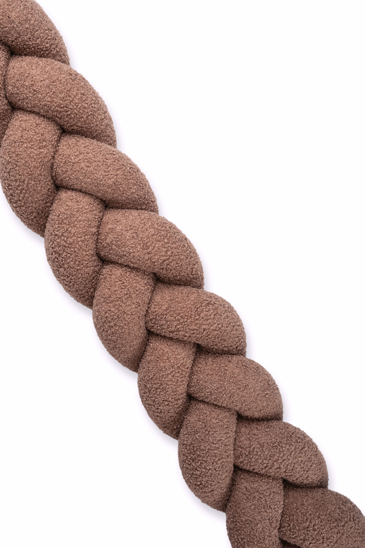 Brown bouclé braid cot bumper close-up showing fluffy and textured fabric detail.