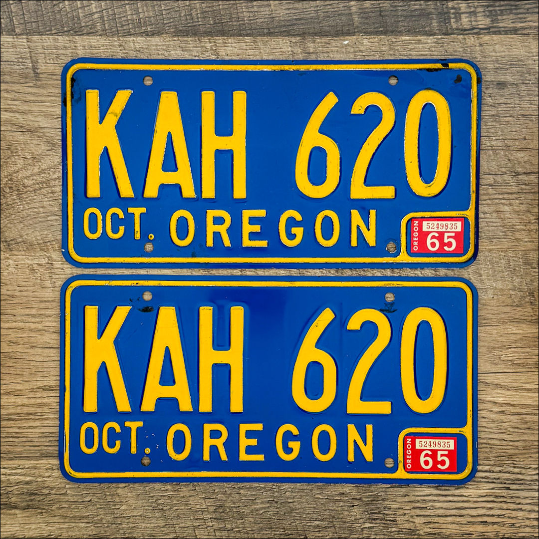 An original pair of Oregon 1965-73 license plates. Yellow on blue.