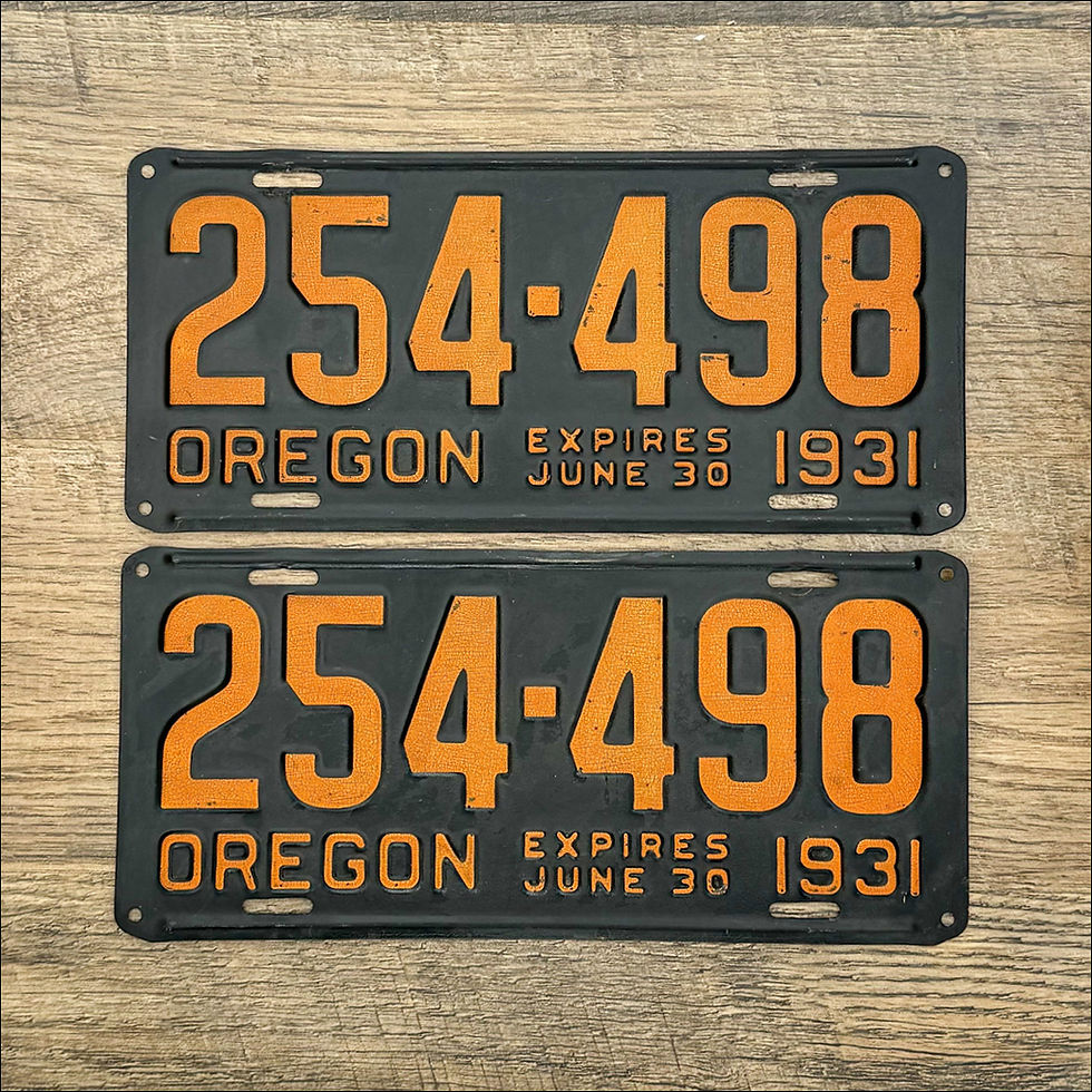 An original pair of Oregon 1931 license plates. Black with orange lettering.