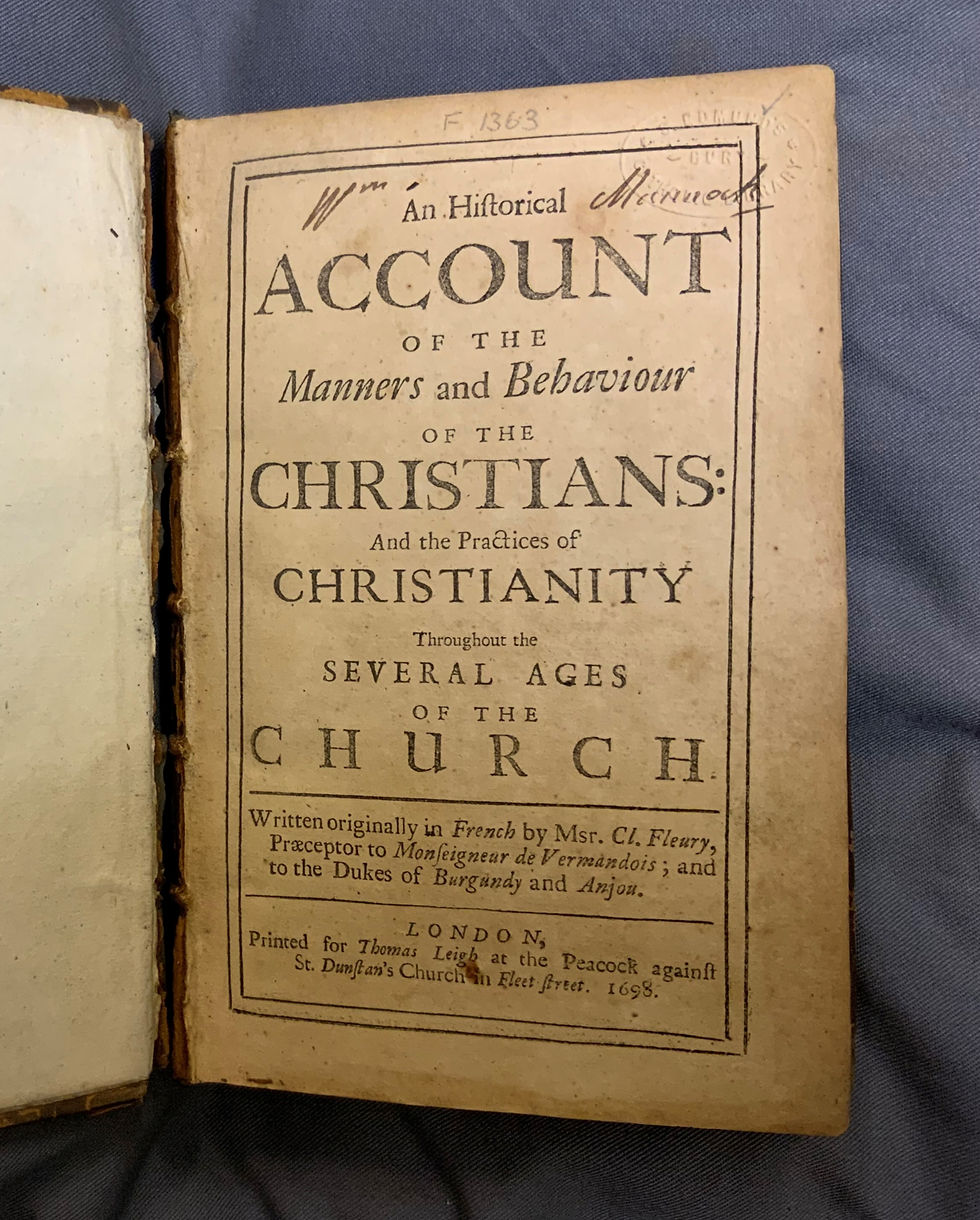Photo of the title page of a book printed in 1698. Written across the top is 'Wm Mannock'.