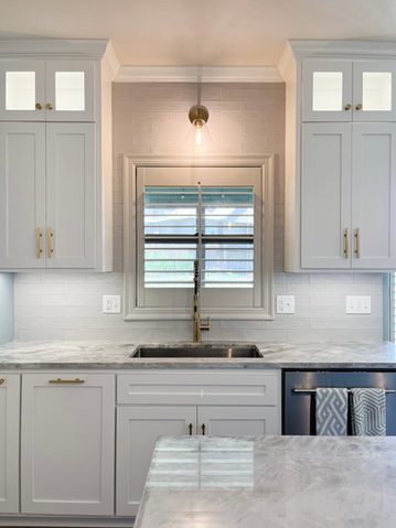 Bright and airy kitchen with white cabinets, stainless steel hardware, and subway tile backsplash