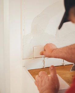 Man Skillfully Setting Ceramic Tiles in Remodeling Project