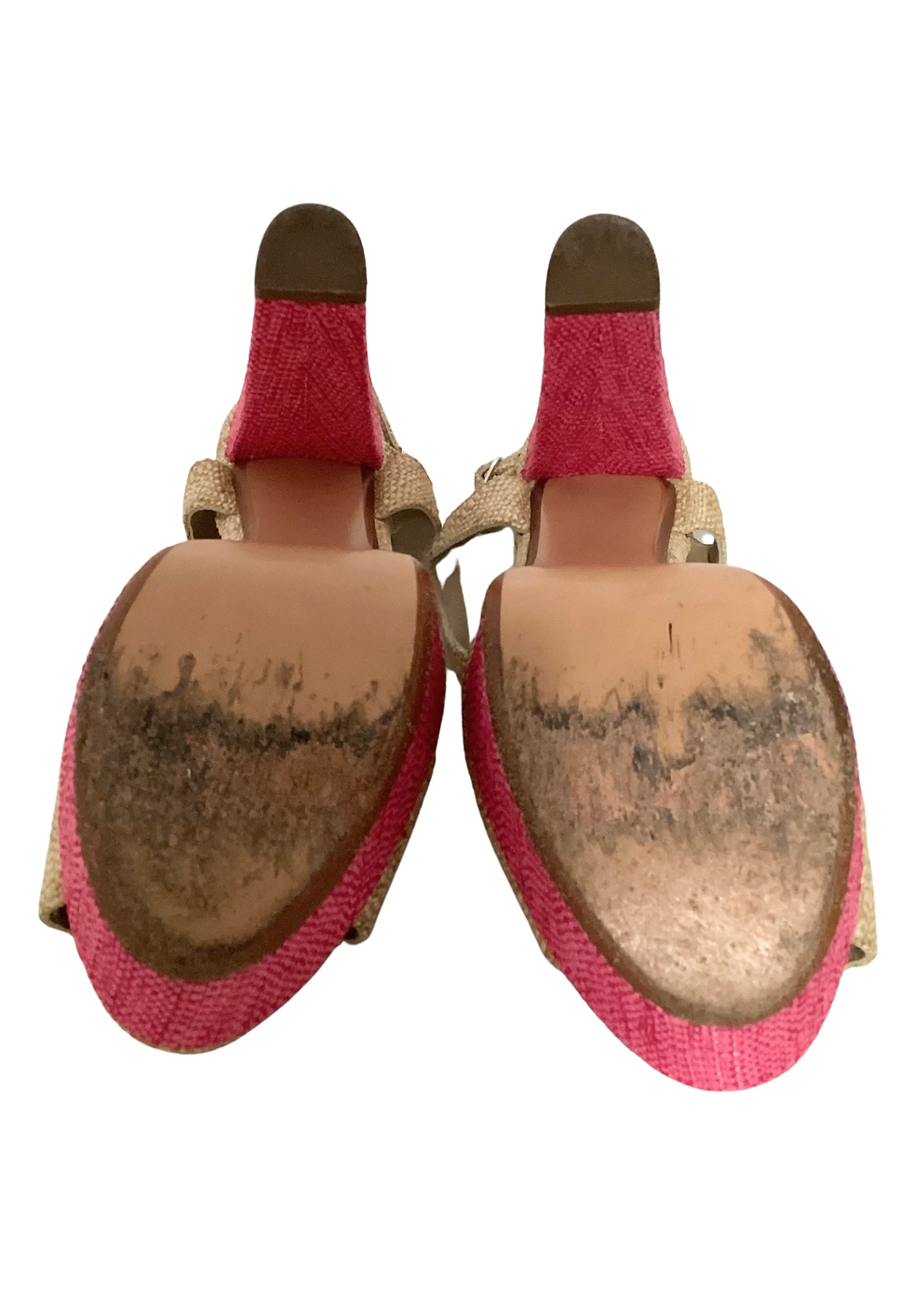 Thumbnail: Worn beige and pink high heels, close-up of the dirty soles of shoes.