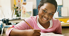 Young Student being writing at desk. Emily Axelrod, English tutor New Jersey