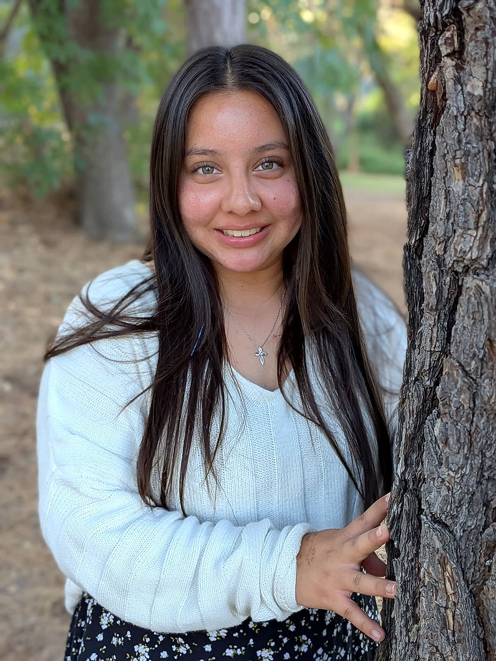 Monica standing by tree