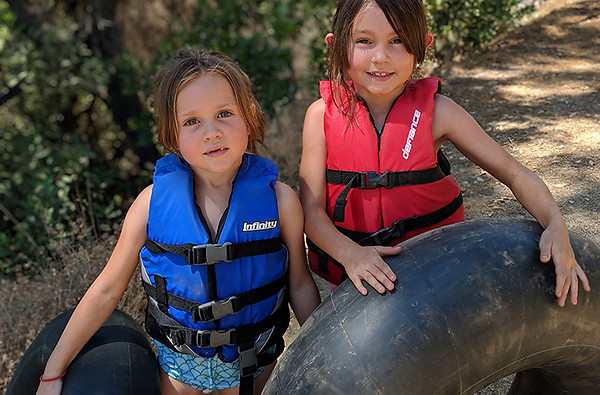 two-girls-in-lifejackets-tubing-in-ditch.jpg