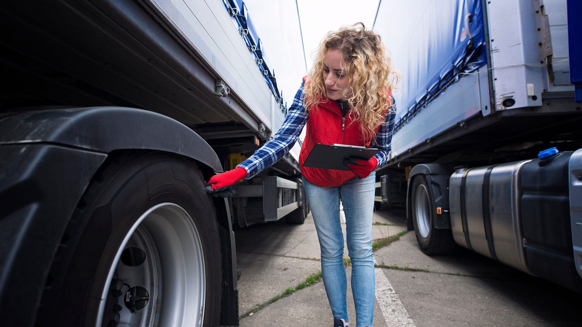 Safety manager inspecting truck equipment for compliance with DOT regulations.