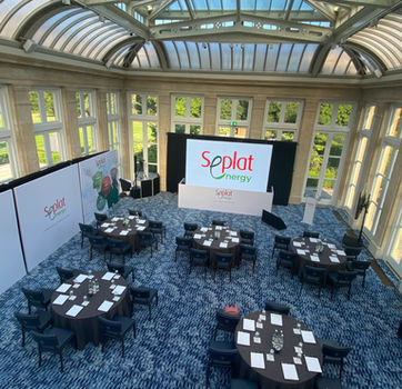 Wide view of boardroom event setup with LED screen wall and branded scenic panels for Seplat Energy 2024