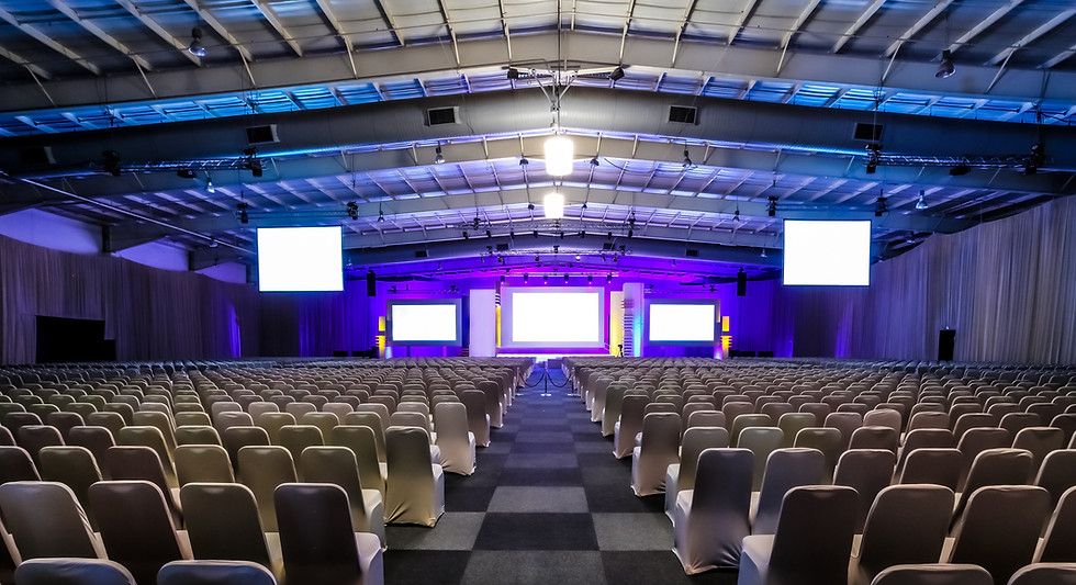 Conference setup with stage and screens