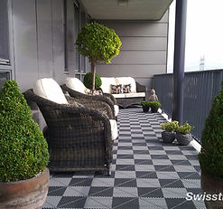 Outdoor porch with black and gray SwissTrax modular floor tiles