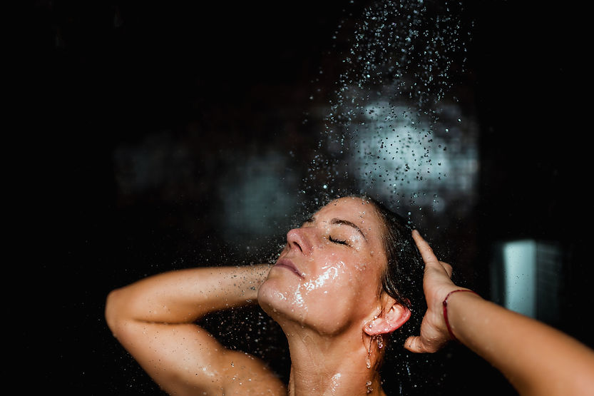 woman enjoying water pressure after new jet pump and pressure tank installation by Advanced Water Systems in Vero Beach and Sebastian